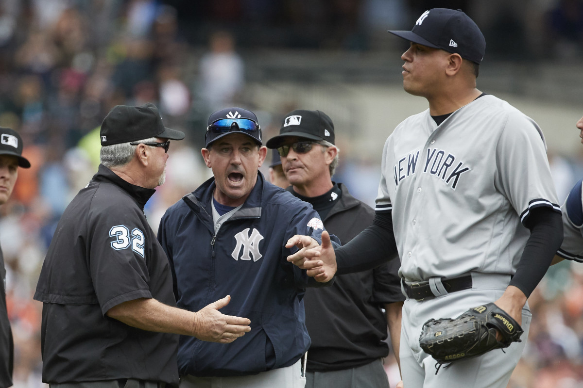 Rob Thomson argues with umpires during his tenure as New York Yankees bench coach.