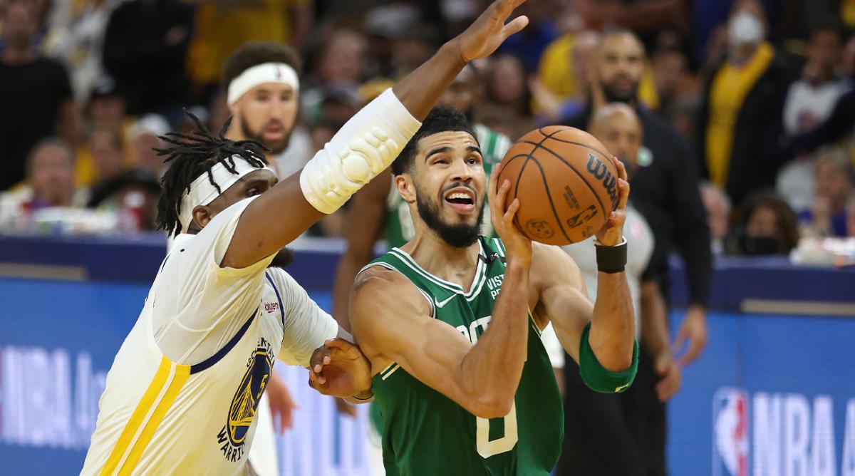 Boston Celtics forward Jayson Tatum (0) drives to the basket against Golden State Warriors center Kevon Looney during the second half of Game 1 of basketball’s NBA Finals in San Francisco, Thursday, June 2, 2022.