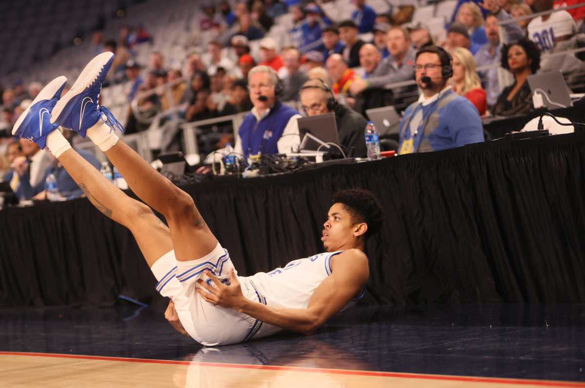 Memphis Tigers Josh Minott is knocked to the floor after being fouled on a 3-point attempt against the UCF Knights.