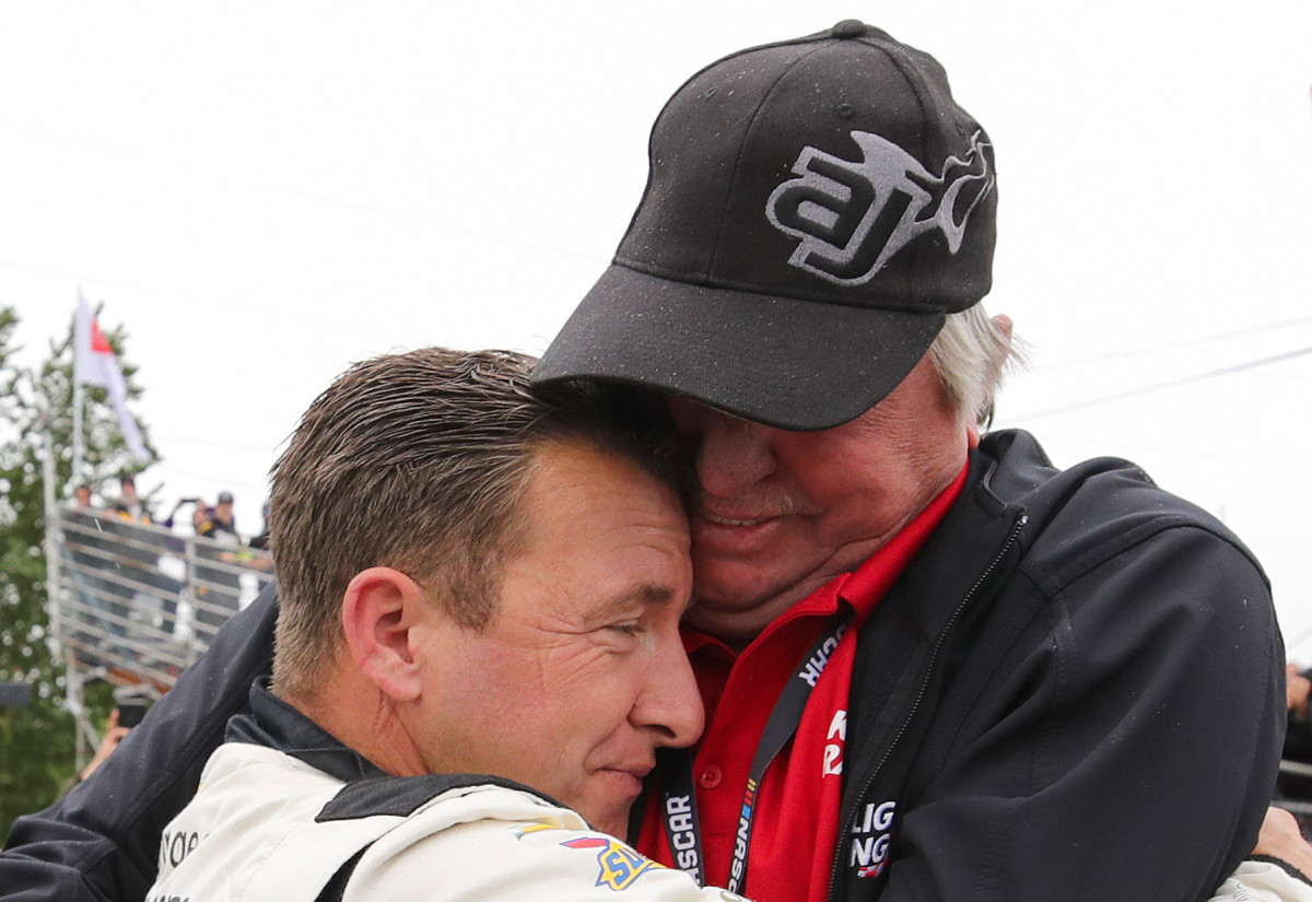AJ Allmendinger is embraced by his father, Greg Allmendinger after winning Saturday's NASCAR Xfinity Series Pacific Office Automation 147 race at Portland International Raceway. (Photo by Meg Oliphant/Getty Images)