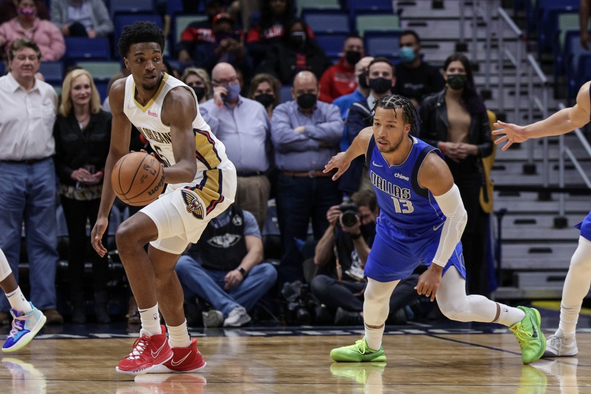 Feb 17, 2022; New Orleans, Louisiana, USA; New Orleans Pelicans forward Herbert Jones (5) dribbles against Dallas Mavericks guard Jalen Brunson (13) during the first half at the Smoothie King Center. Mandatory Credit: Stephen Lew-USA TODAY Sports