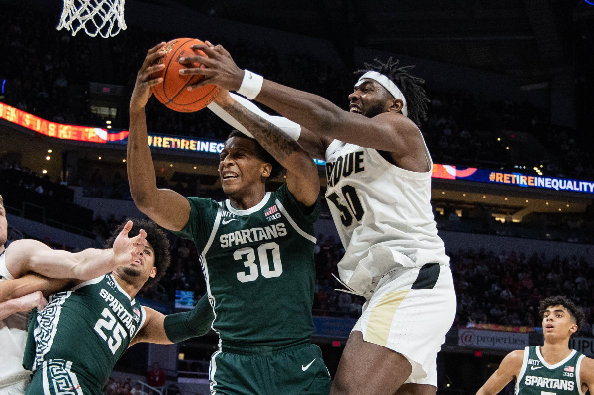 Purdue Boilermakers forward Trevion Williams (50) and Michigan State Spartans forward Marcus Bingham Jr. (30) fight for a rebound in the first half at Gainbridge Fieldhouse.