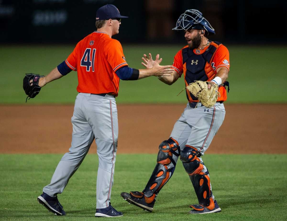 Auburn Tigers pitcher John Armstrong (41) and catcher Jake Wyandt (50) celebrate after the final out during the NCAA regional baseball tournament at Plainsman Park in Auburn, Ala., on Saturday, June 4, 2022. Auburn Tigers defeated Florida State Seminoles 21-7.