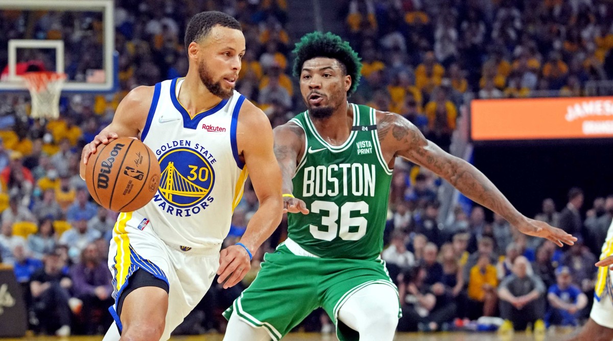 Stephen Curry dribbling with Marcus Smart defending