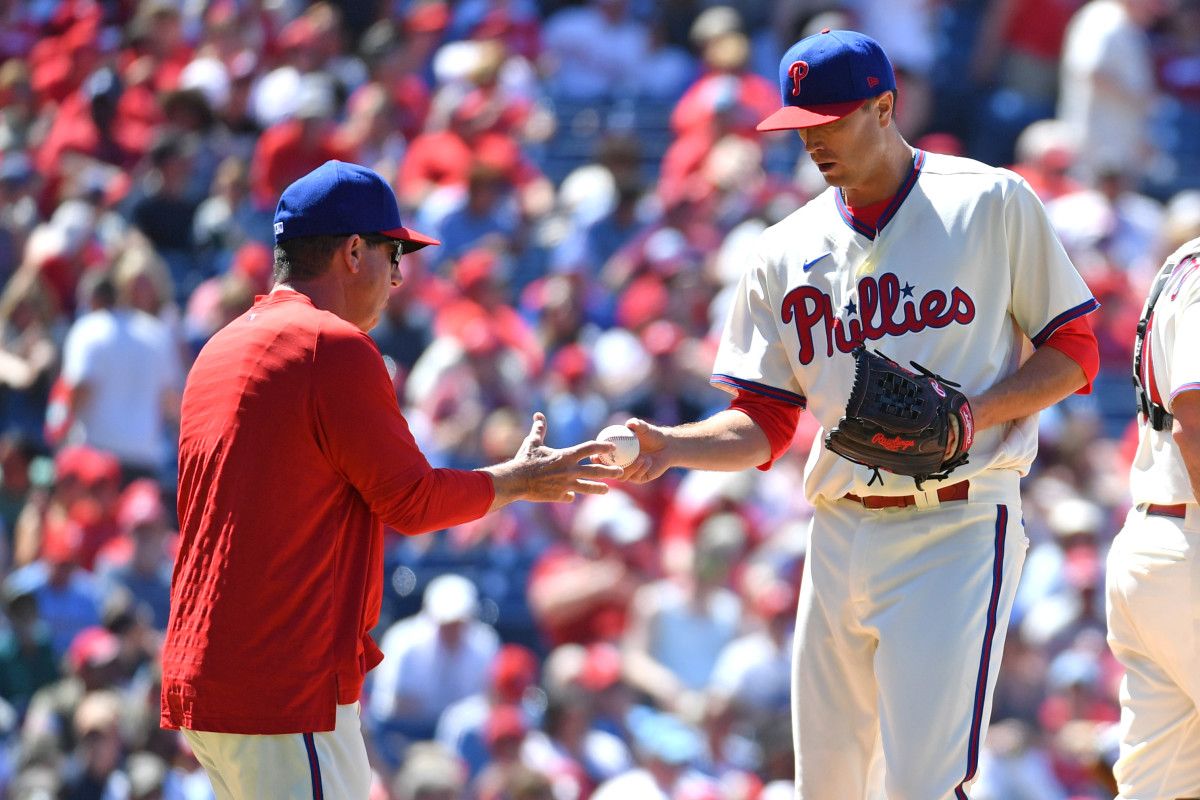Kyle Gibson hands the ball to new manager Rob Thomson after getting roughed up in the fourth inning on Sunday.