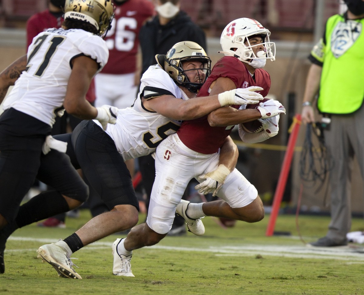 Colorado Buffaloes linebacker Nate Landman (53) brings down Stanford Cardinal wide receiver Michael Wilson (4) during the fourth quarter of an NCAA college football game at Stanford Stadium.