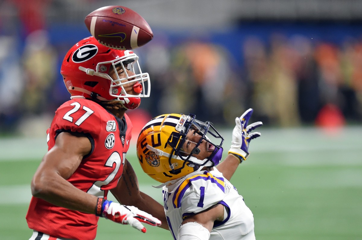 Georgia Bulldogs defensive back Eric Stokes (27) breaks up a pass intended for LSU Tigers wide receiver Ja'Marr Chase (1) during the first quarter of the the 2019 SEC Championship Game at Mercedes-Benz Stadium.