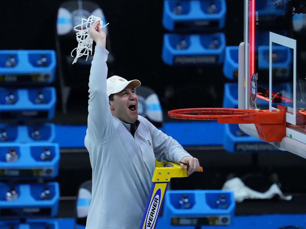 Scott Drew holds up the net after Baylor's win