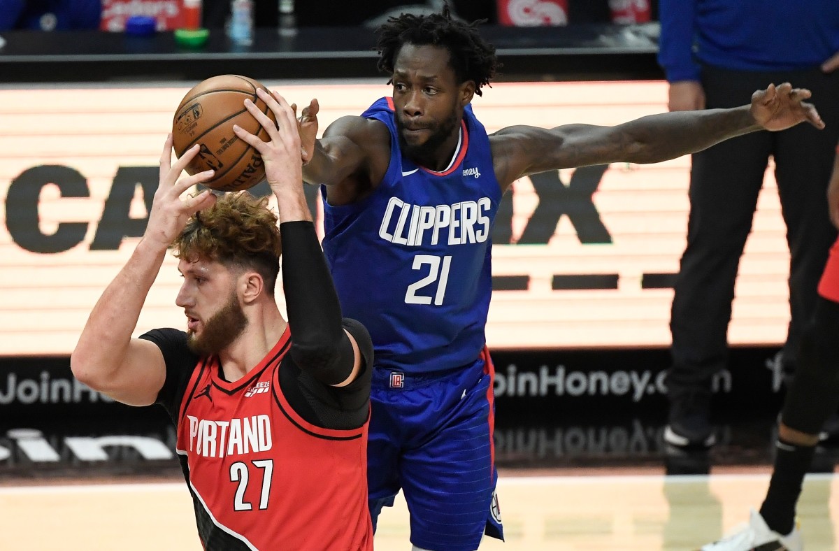 Dec 30, 2020; Los Angeles, California, USA; LA Clippers guard Patrick Beverley (21) tries to steal the ball from Portland Trail Blazers center Jusuf Nurkic (27) during the first quarter at Staples Center. Mandatory Credit: Robert Hanashiro-USA TODAY Sports