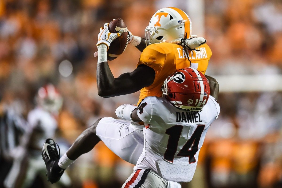 Tennessee Volunteers wide receiver Marquez Callaway (1) makes a catch over Georgia Bulldogs defensive back DJ Daniel (14) during the first quarter at Neyland Stadium.
