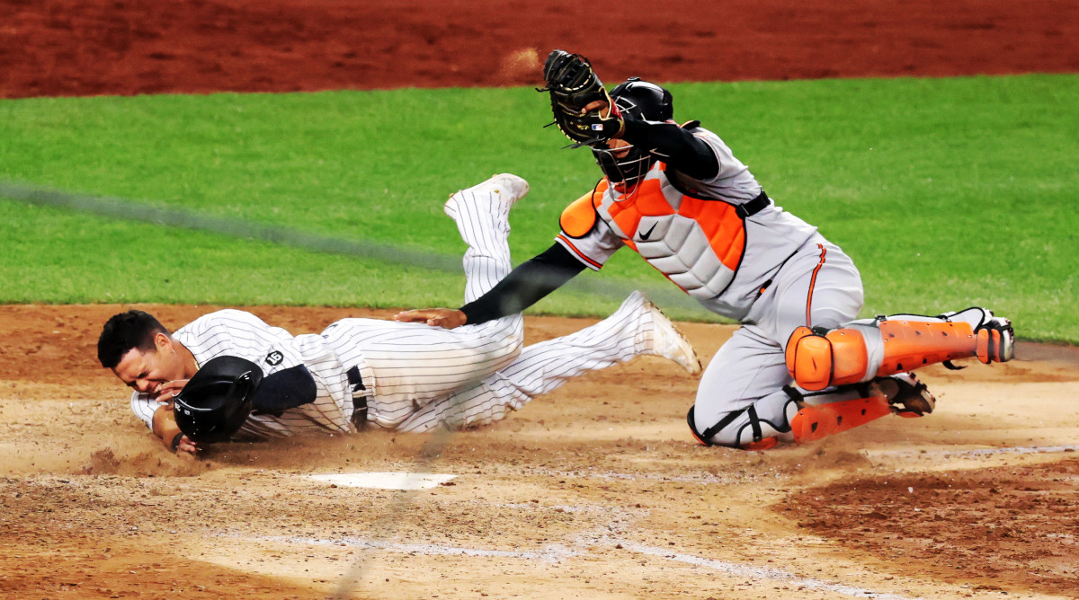 Baltimore Orioles catcher Pedro Severino (28) tags out New York Yankees third baseman Gio Urshela (29) at home plate to end the game on a double play in the 11th inning at Yankee Stadium.