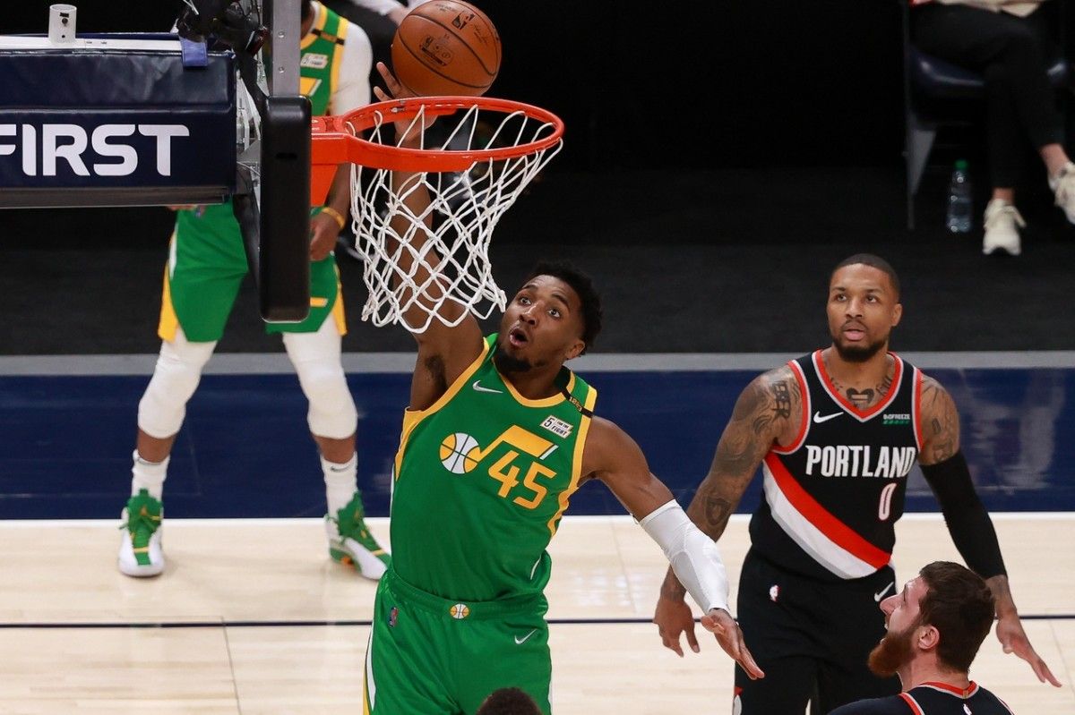 Donovan Mitchell (45) scores two points over Damian Lillard (0) and the Portland Trail Blazers