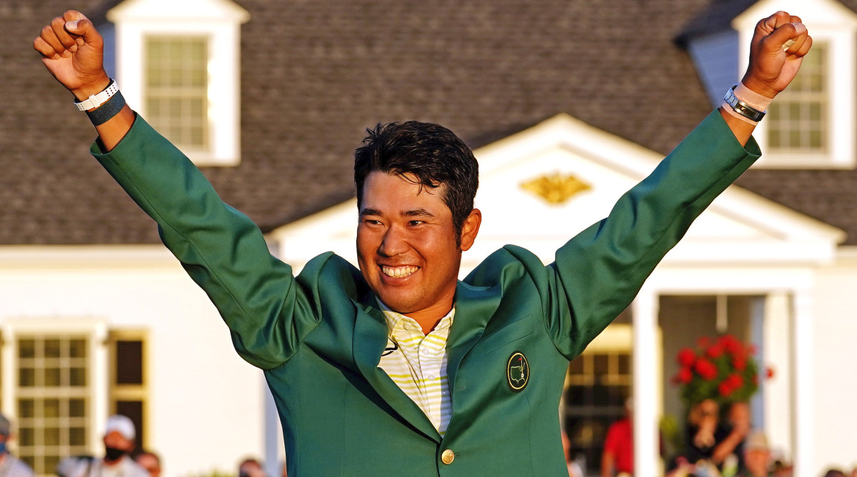 Hideki Matsuyama celebrates with the green jacket after winning the Masters golf tournament.