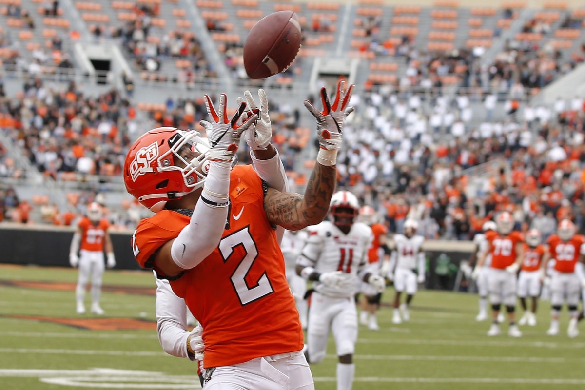 Oklahoma State Cowboys wide receiver Tylan Wallace (2) catches a touchdown pass during a football game against Texas Tech at Boone Pickens Stadium.