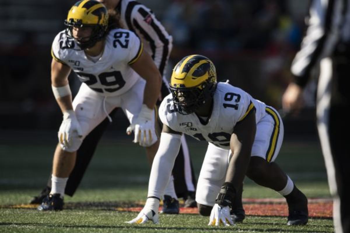 Michigan Wolverines defensive lineman Kwity Paye (19) and linebacker Jordan Glasgow (29) prior to the snap during the \2g\ against the Maryland Terrapins at Capital One Field at Maryland Stadium.