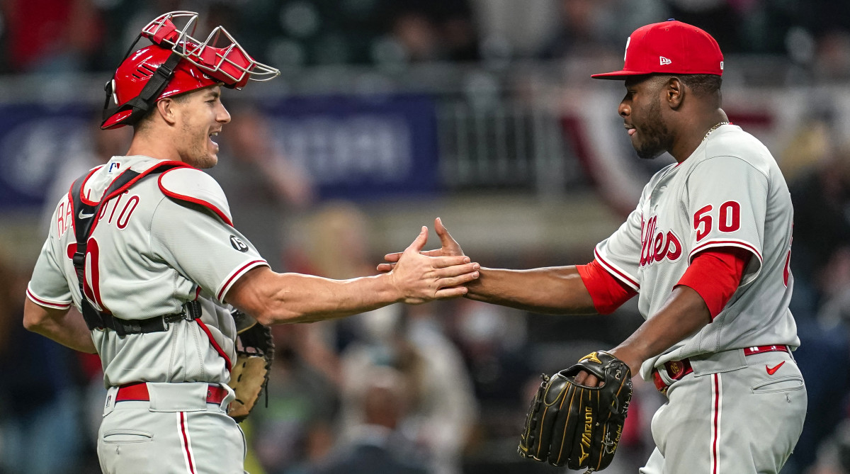 Phillies relief pitcher Héctor Neris celebrates with catcher J.T. Realmuto after beating the Braves.