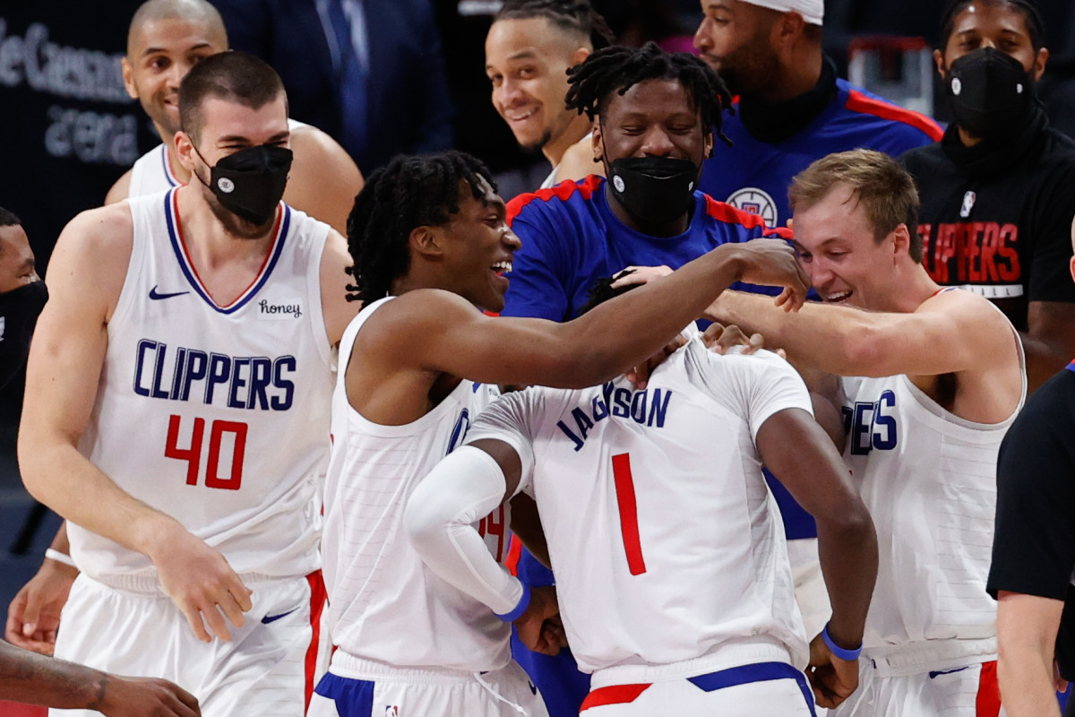 Apr 14, 2021; Detroit, Michigan, USA; LA Clippers guard Reggie Jackson (1) is congratulated by teammates after the game against the Detroit Pistons at Little Caesars Arena. Mandatory Credit: Rick Osentoski-USA TODAY Sports