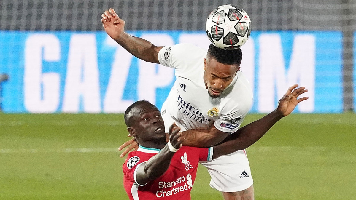 Real Madrid's Eder Militao heads the ball away from Liverpool's Sadio Mane