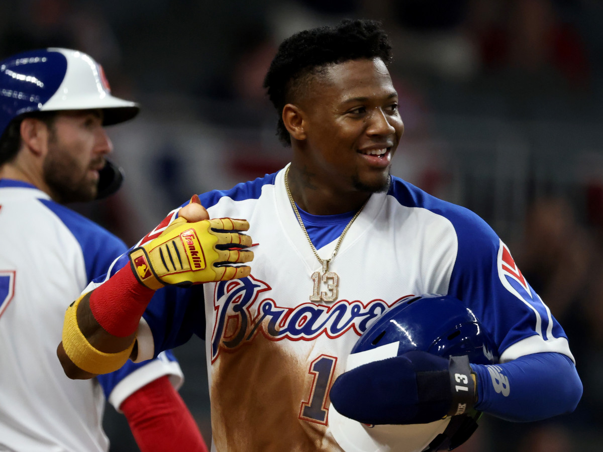 Ronald Acuna Jr. smiles after scoring a run.