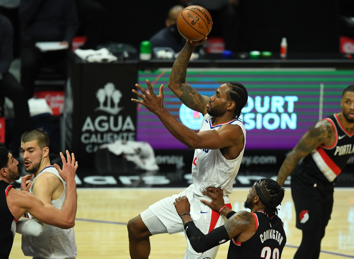 Apr 6, 2021; Los Angeles, California, USA; Los Angeles Clippers forward Kawhi Leonard (2) goes up for a basket past Portland Trail Blazers forward Robert Covington (23) in the first half of the game at Staples Center. Mandatory Credit: Jayne Kamin-Oncea-USA TODAY Sports