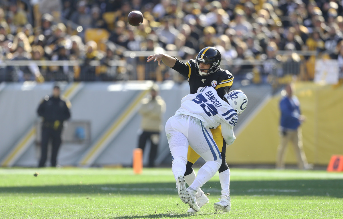 Nov 3, 2019; Pittsburgh, PA, USA; Pittsburgh Steelers quarterback Mason Rudolph (2) passes as he is hit by Indianapolis Colts defensive end Ben Banogu (52) during the second quarter at Heinz Field. Mandatory Credit: Charles LeClaire-USA TODAY Sports