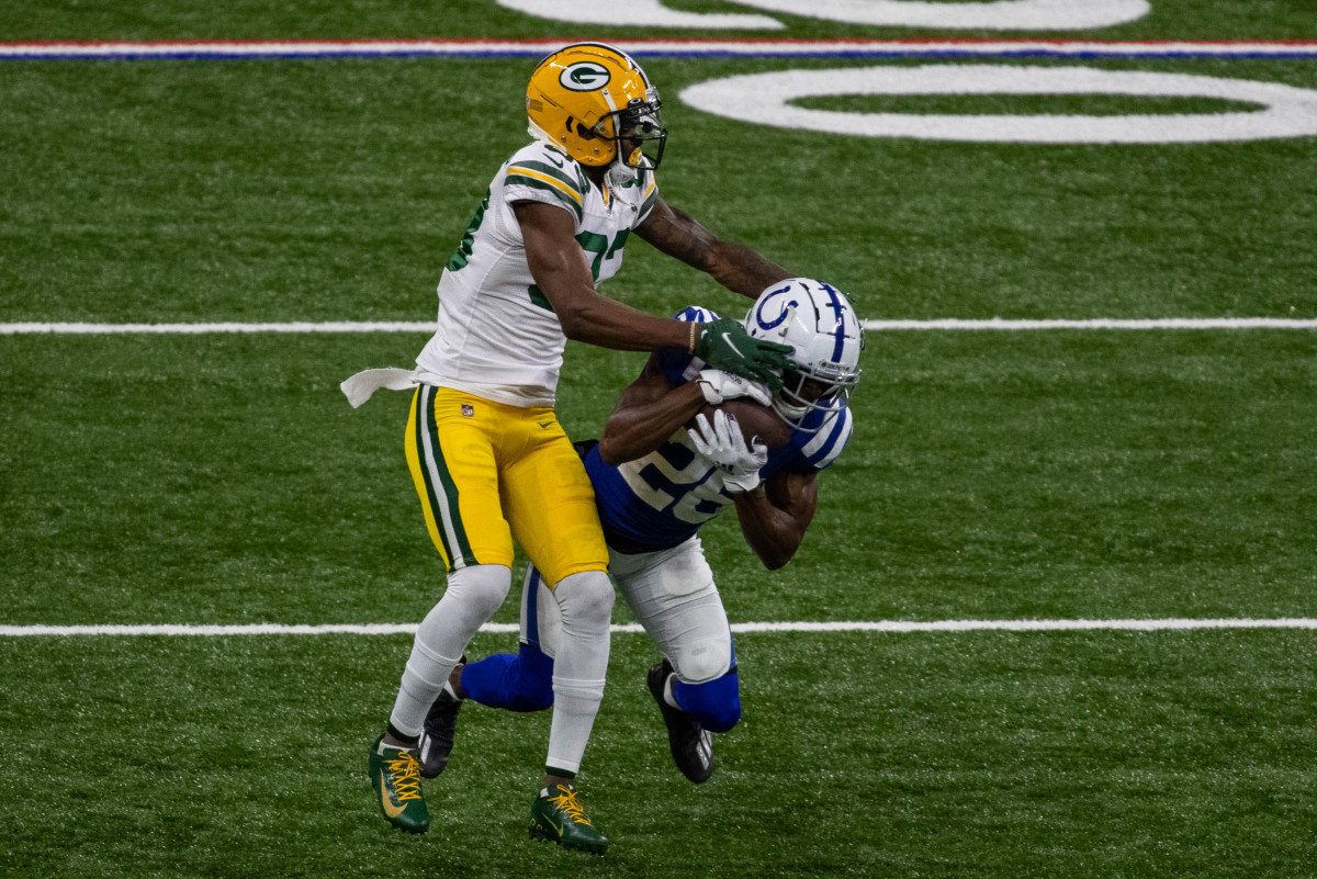 Nov 22, 2020; Indianapolis, Indiana, USA; Indianapolis Colts cornerback Rock Ya-Sin (26) intercepts the ball from Green Bay Packers wide receiver Marquez Valdes-Scantling (83) in the first half at Lucas Oil Stadium. Mandatory Credit: Trevor Ruszkowski-USA TODAY Sports