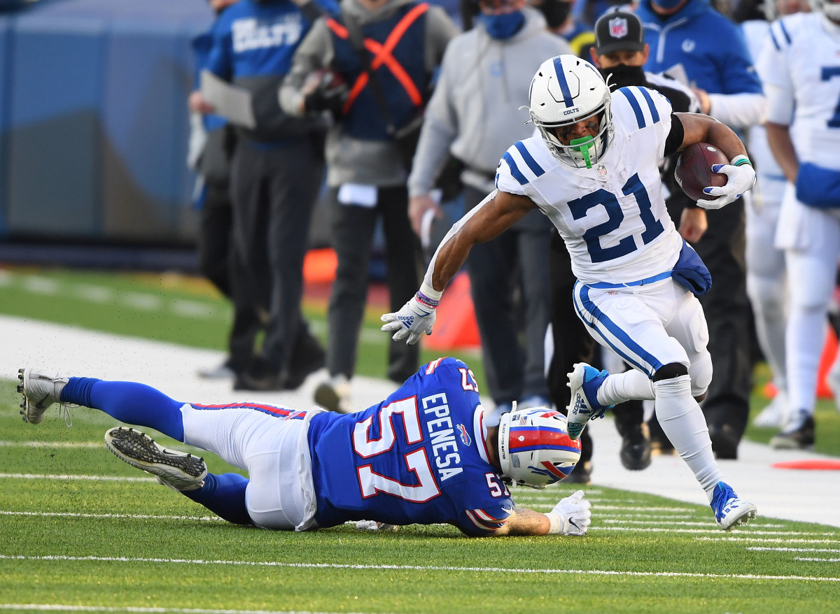 Jan 9, 2021; Orchard Park, New York, USA; Indianapolis Colts running back Nyheim Hines (21) runs the ball ahead of Buffalo Bills defensive end A.J. Epenesa (57) during the second half in the AFC Wild Card game at Bills Stadium. Mandatory Credit: Rich Barnes-USA TODAY Sports