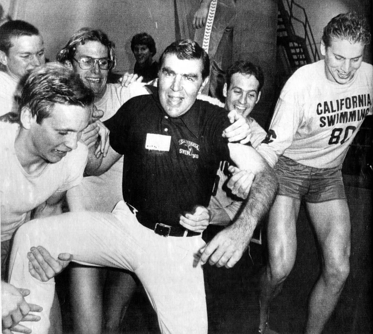 Nort Thornton's swimmers toss him in the pool