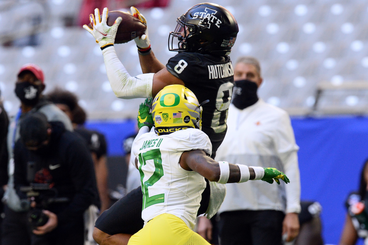 DJ James (12) in pass coverage against Iowa State wide receiver Xavier Hutchinson (8) in the 2021 Playstation Fiesta Bowl.