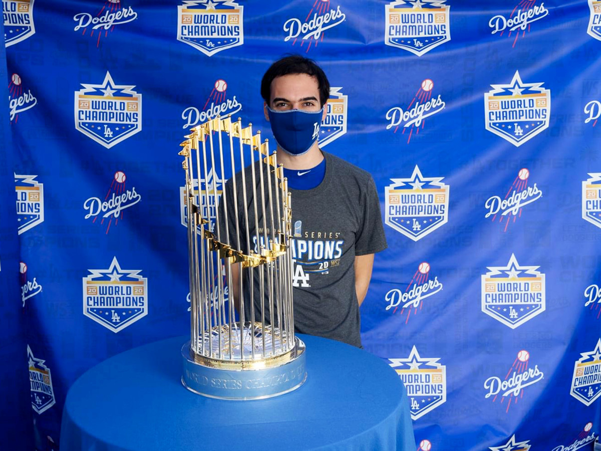 Mets director of baseball analytics Ben Zauzmer, who worked in the Dodgers' front office from 2015-20, poses with the 2020 World Series trophy.