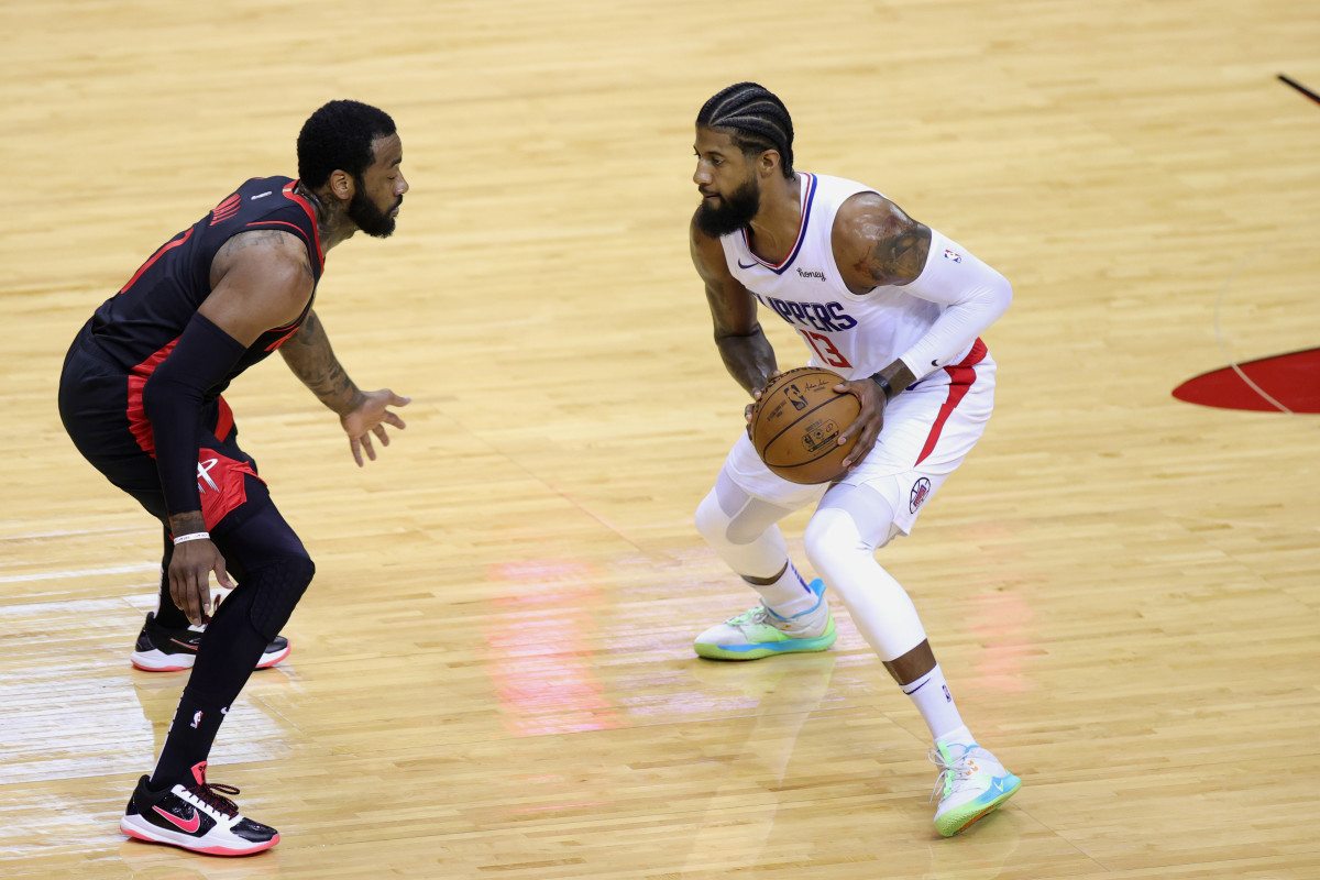 Apr 23, 2021; Houston, Texas, USA; Paul George #13 of the Los Angeles Clippers dribbles against John Wall #1 of the Houston Rockets during the first quarter at Toyota Center. Mandatory Credit: Carmen Mandato/POOL PHOTOS-USA TODAY Sports