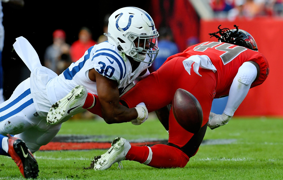 Dec 8, 2019; Tampa, FL, USA; Indianapolis Colts defensive back George Odum (30) forces the fumble of Tampa Bay Buccaneers running back Dare Ogunbowale (44) during the first half at Raymond James Stadium. Mandatory Credit: Jasen Vinlove-USA TODAY Sports