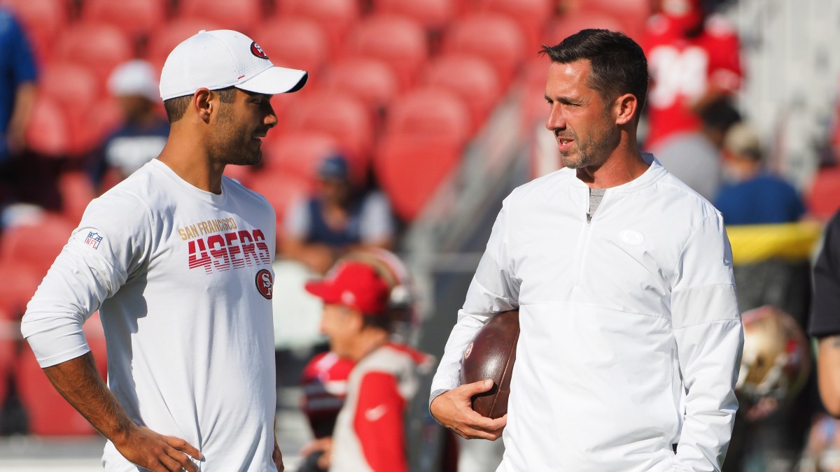 49ers head coach Kyle Shanahan speaks to quarterback Jimmy Garoppolo on the field