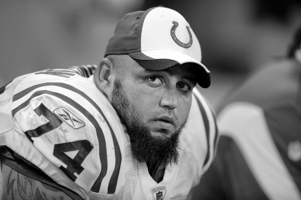Black and white photo of Colts lineman Charlie Johnson on the bench