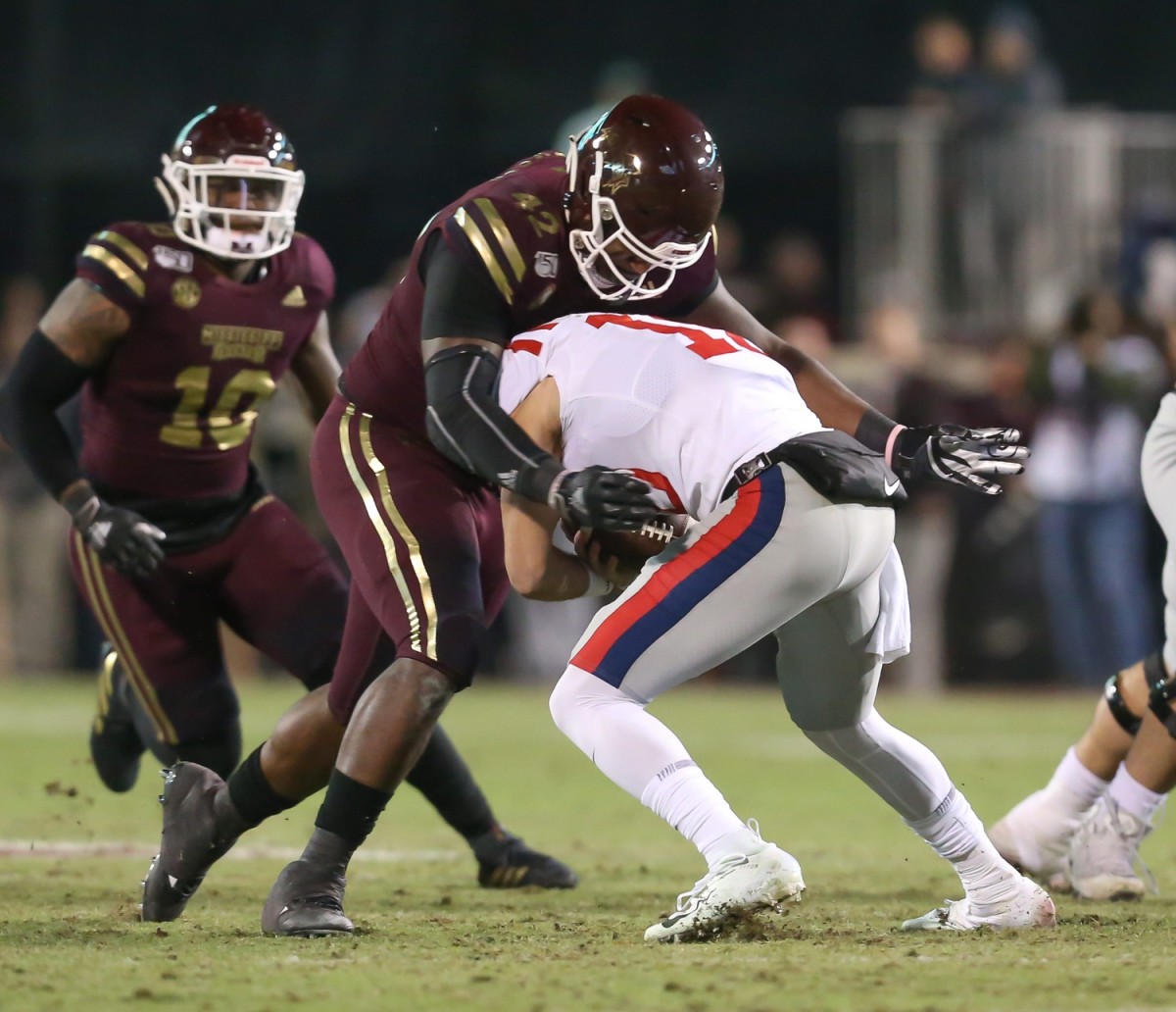 Mississippi State's Marquiss Spencer (42) tackles Ole Miss's John Rhys Plumlee (10). Mississippi State and Ole Miss played in the Egg Bowl on Thursday, November 28, 2019 at Davis Wade Stadium in Starkville. 2019 Egg Bowl