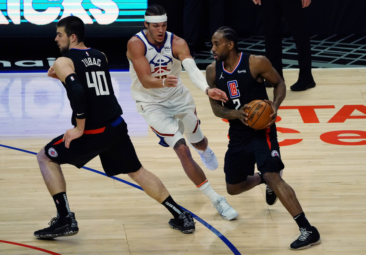 Apr 1, 2021; Los Angeles, California, USA; Los Angeles Clippers forward Kawhi Leonard (2) moves the ball as center Ivica Zubac (40) provides coverage against Denver Nuggets forward Aaron Gordon (50) during the first half at Staples Center. Mandatory Credit: Gary A. Vasquez-USA TODAY Sports