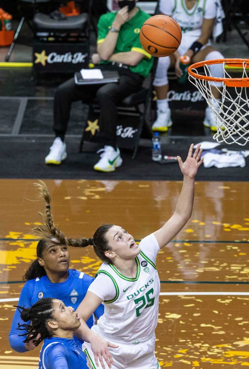 Angela Dugalic (25) watches as her shot goes through the net in a home game against No. 11 UCLA on January 3, 2021 at Matthew Knight Arena in Eugene, Oregon.
