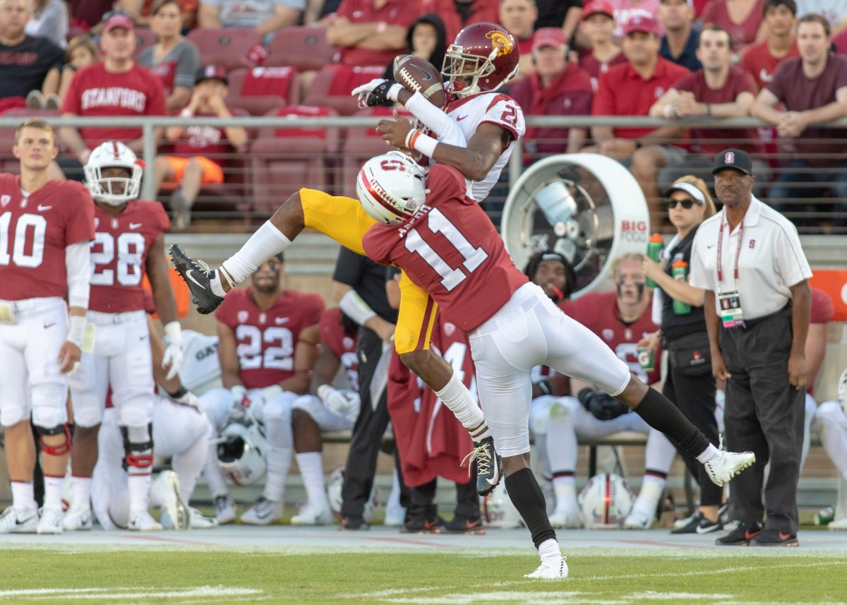 Stanford Cardinal cornerback Paulson Adebo (11) strips the ball from USC receiver Tyler Vaughns (21). Mandatory Credit: Neville E. Guard-USA TODAY 