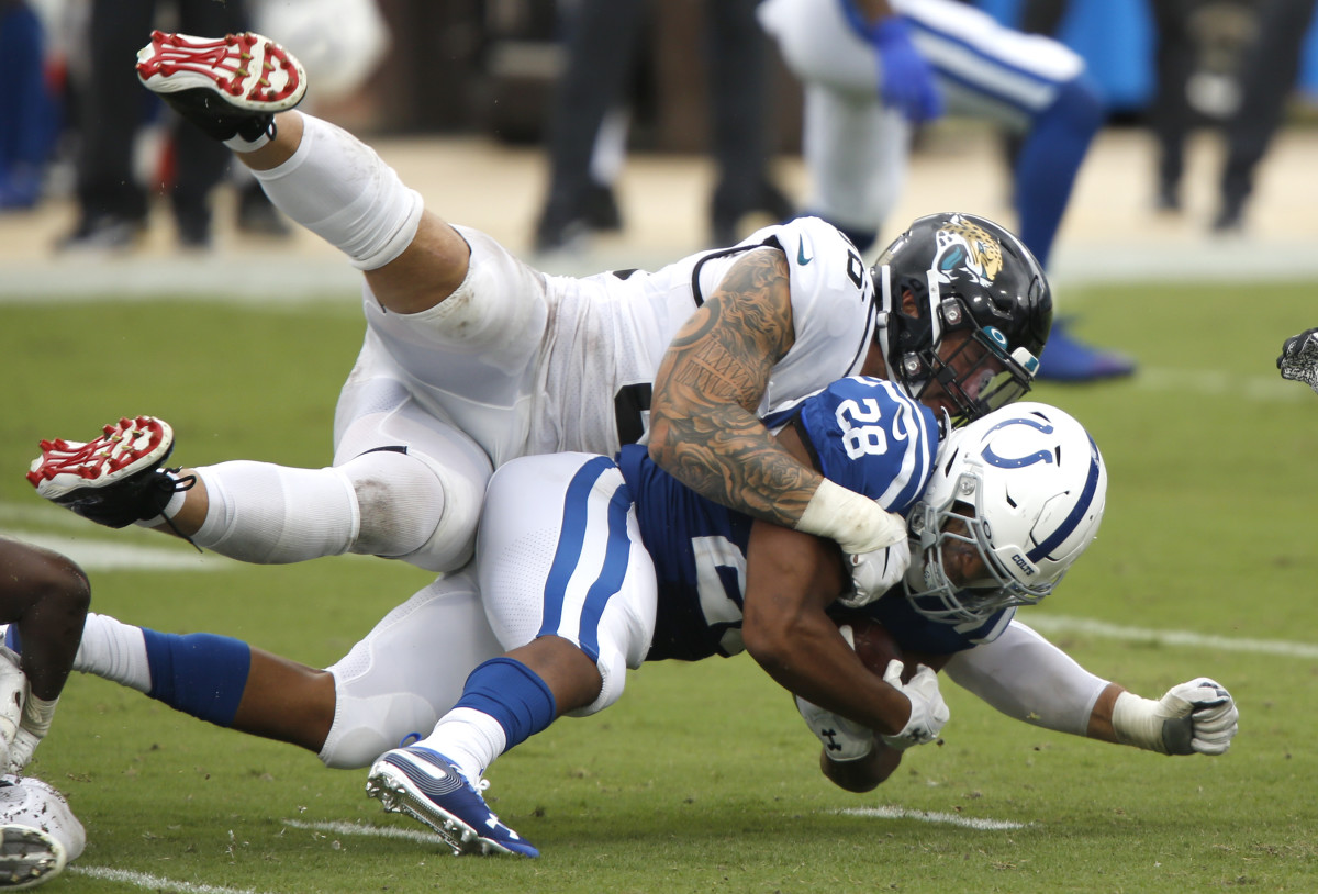 Gotsis tackles Indianapolis Colts running back Jonathan Taylor. Mandatory Credit: Reinhold Matay-USA TODAY Sports