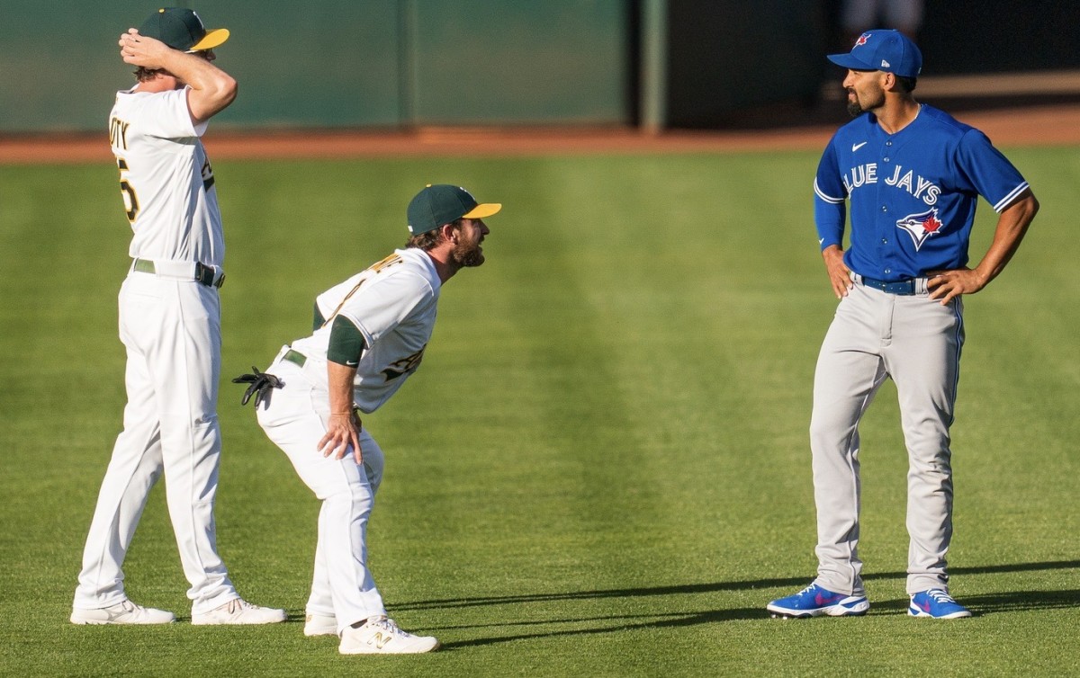 Marcus Semien, right, chats with former A's teammates
