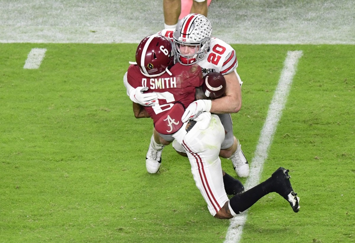 Alabama receiver DeVonta Smith (6) is hit by Ohio State linebacker Pete Werner (20) in the 2021 College Football Playoff National Championship Game. Mandatory Credit: Douglas DeFelice-USA TODAY Sports