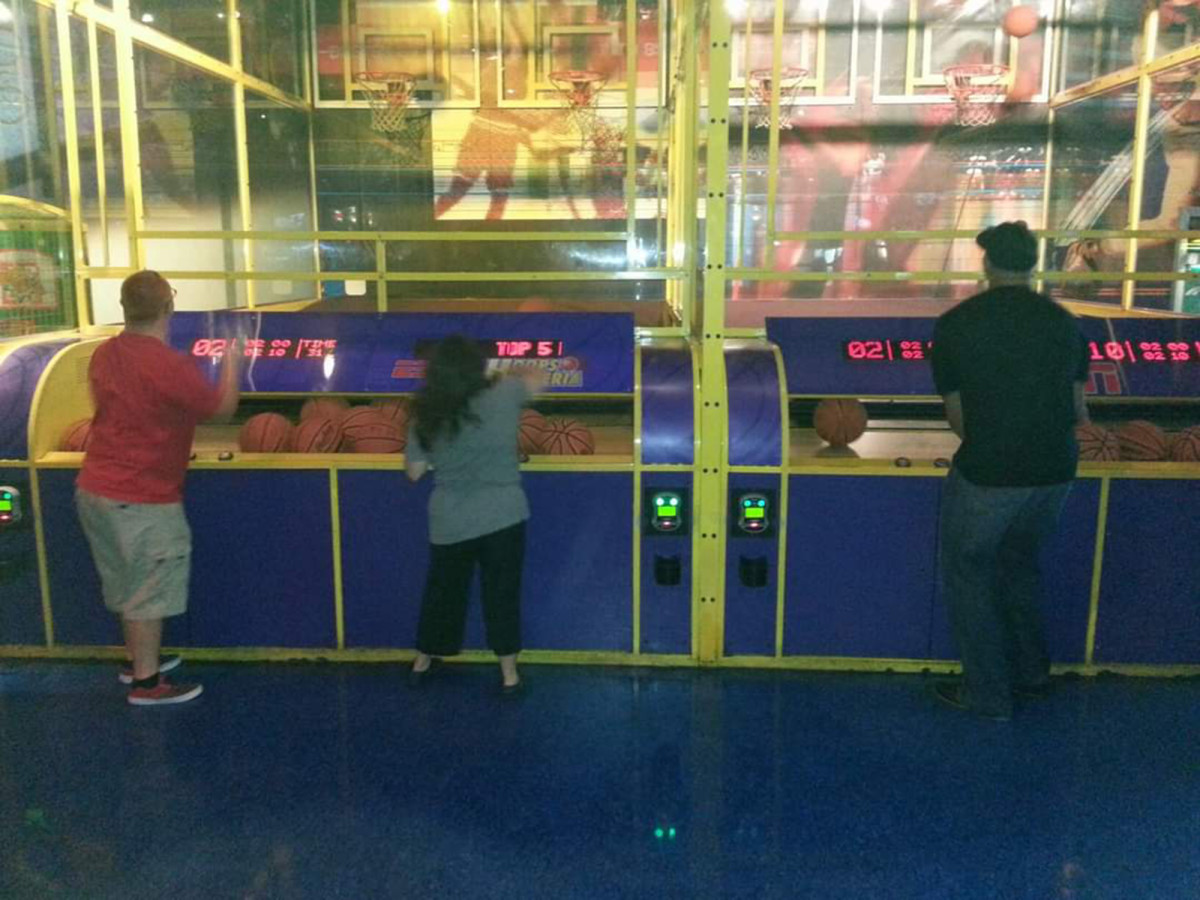 Albert Pujols plays pop-a-shot basketball with Alex Tuchowski and her friend Nate.