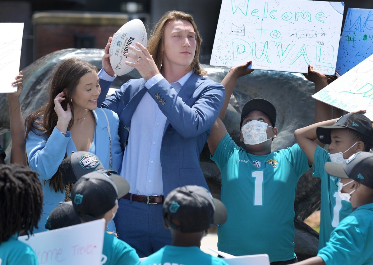 Trevor Lawrence and his wife Marissa Mowry pose with students from Long Branch Elementary School upon their arrival in Jacksonville Friday. The Jacksonville Jaguars' first-round draft pick Trevor Lawrence and his wife Marissa Mowry arrived at TIAA Bank Field in Jacksonville, Florida about noon Friday, April 30, 2021. The couple was greeted by team owner Shad Khan and 35 third-grade students from Long Branch Elementary School.