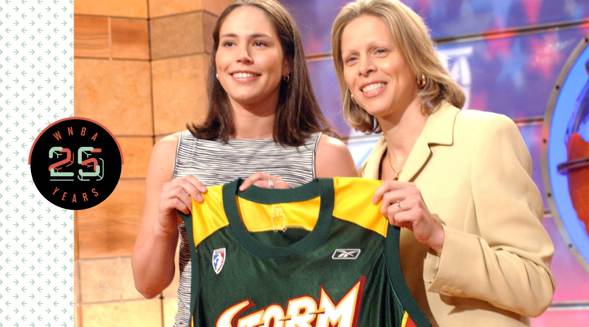 Sue Bird holding up a Seattle Storm jersey