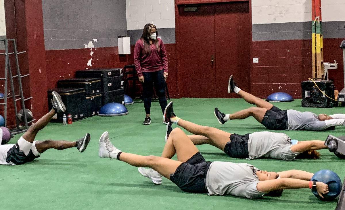 Cynthia Cooper looks on as her players work out on the ground