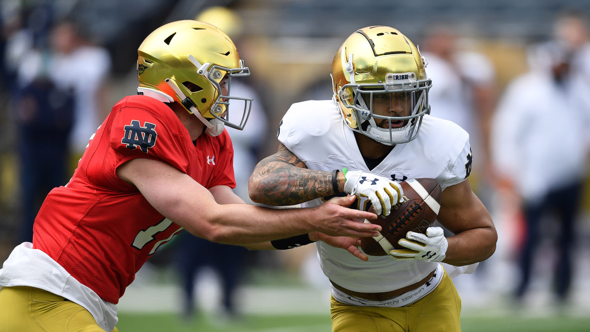 Notre Dame's Jack Coan hands the ball off to Kyren Williams in spring camp