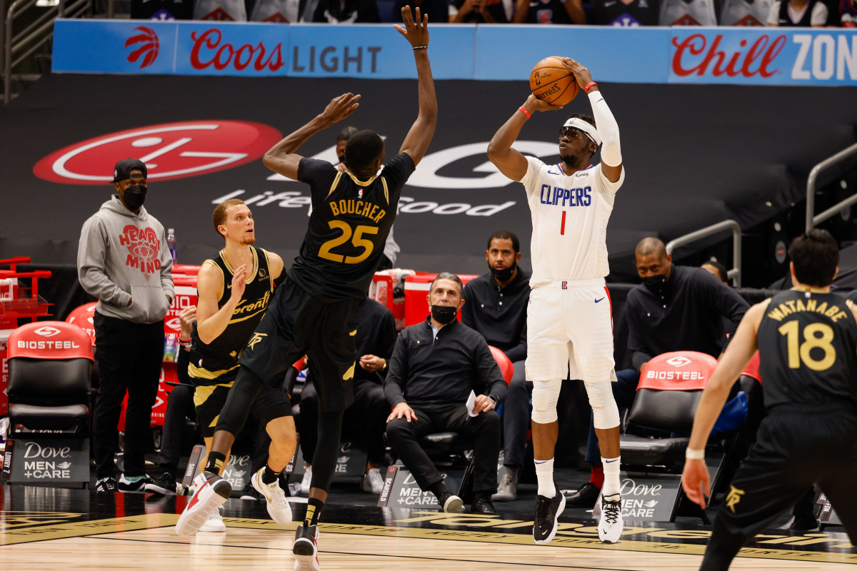 May 11, 2021; Tampa, Florida, USA; LA Clippers guard Reggie Jackson (1) shoots a three-point shot over Toronto Raptors forward Chris Boucher (25) in the third quarter at Amalie Arena. Mandatory Credit: Nathan Ray Seebeck-USA TODAY Sports