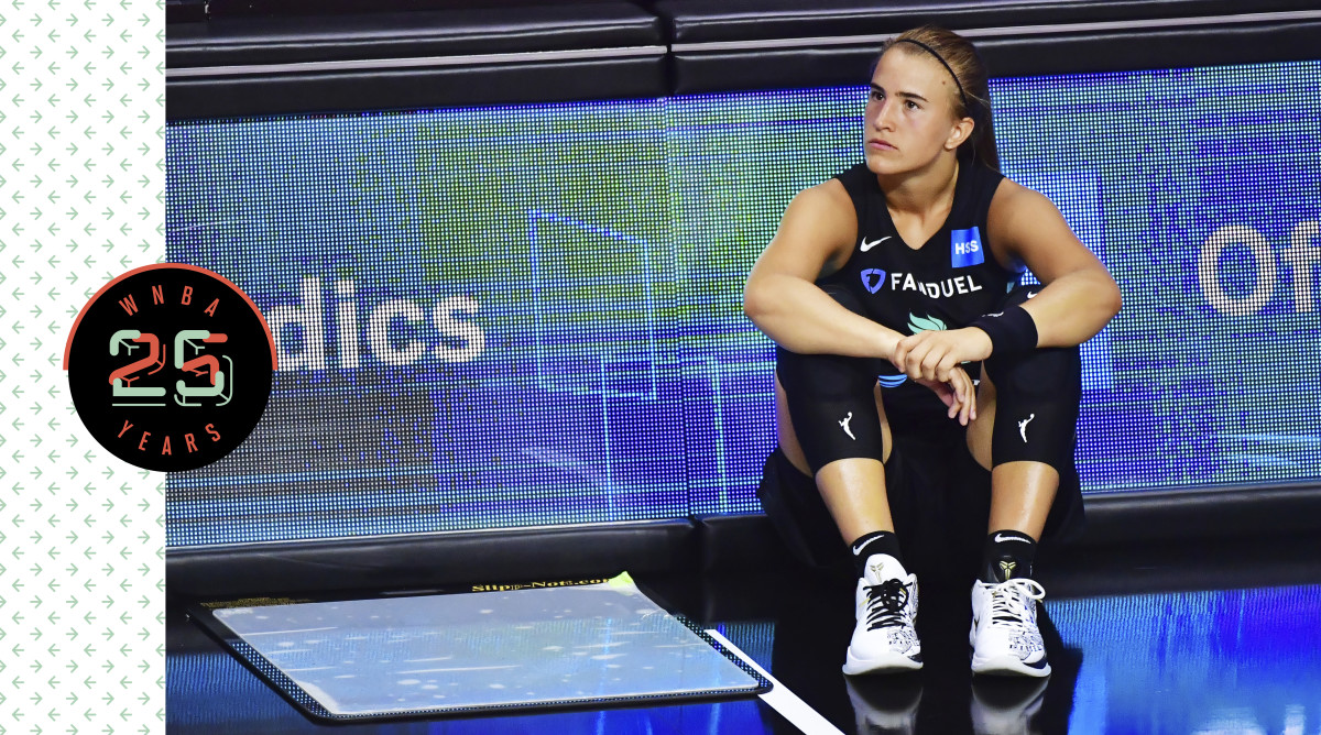 Sabrina Ionescu sitting on the court, looking pensive