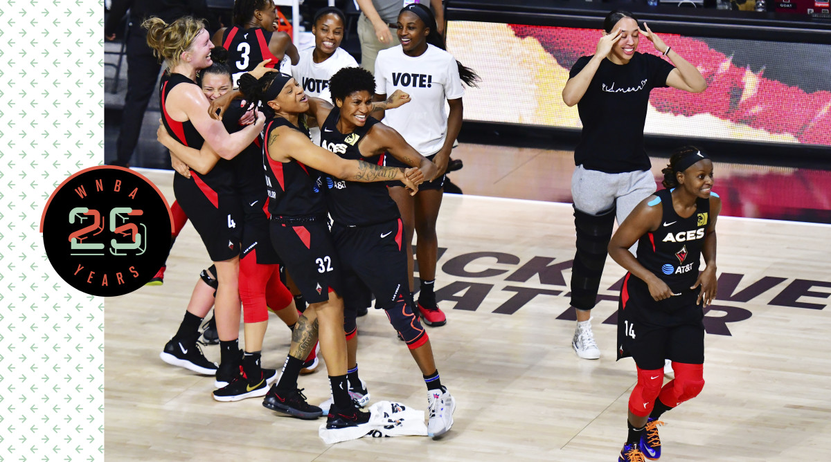 The Las Vegas Aces hug and celebrate on the court.