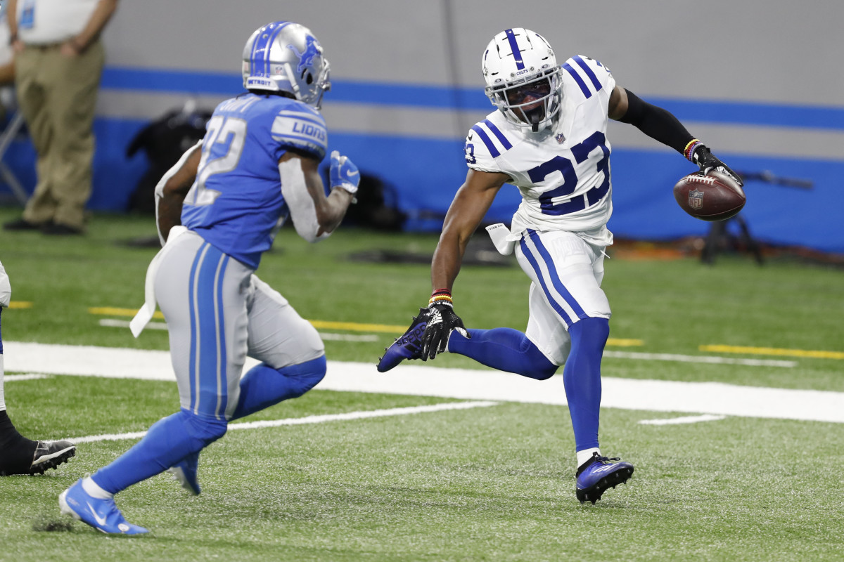 Nov 1, 2020; Detroit, Michigan, USA; Indianapolis Colts cornerback Kenny Moore II (23) runs past Detroit Lions running back D'Andre Swift (32) for a touchdown after making an interception during the fourth quarter at Ford Field.